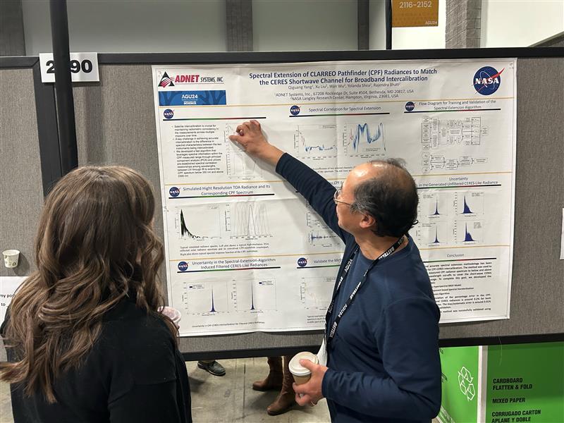 Dr. Qiguang Yang discusses his science results at the poster session with colleagues at the Fall AGU Annual Meeting in December 2024.